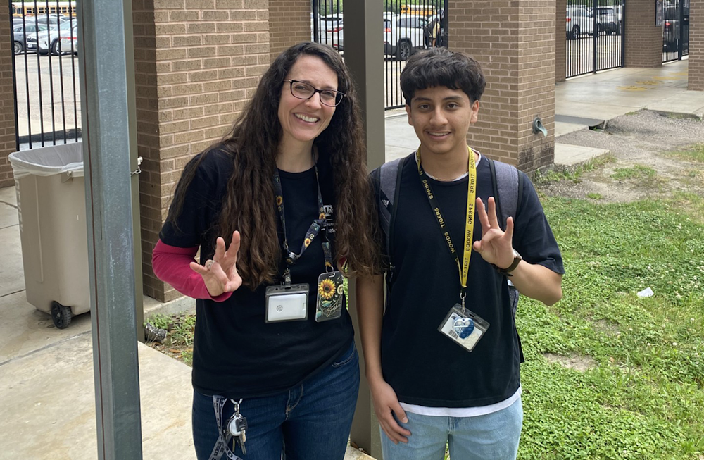 Student with teacher smiling
