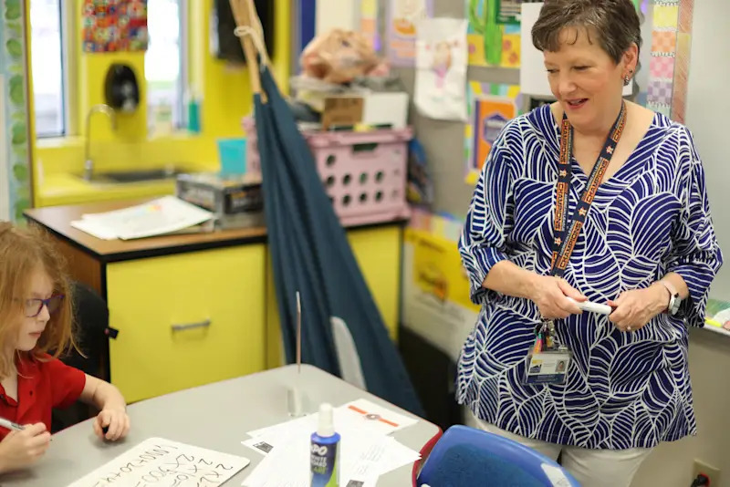 Sharon Sealy next to a student