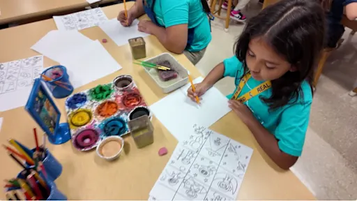 young student painting with watercolor