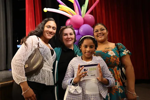 student holding character without question award