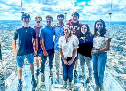 a group of students posing in a skyscraper viewing deck