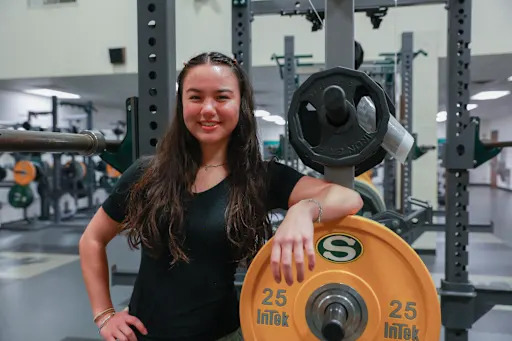 Nicole Abbey smiling in the weight room