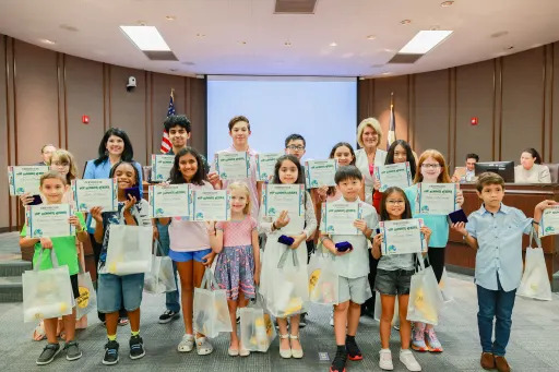 Students holding certificates for reading achievement