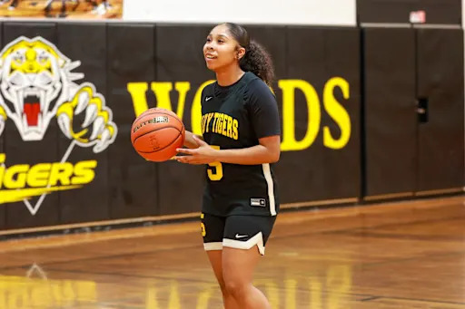 Anjalena Salazar holding a basketball on Spring Woods' court