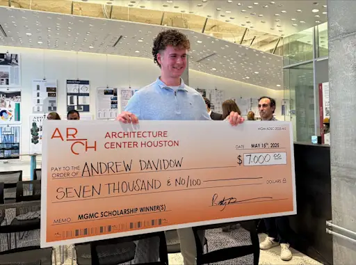 Andrew Davidow holding a large novelty check from Architecture Center Houston for $7,000