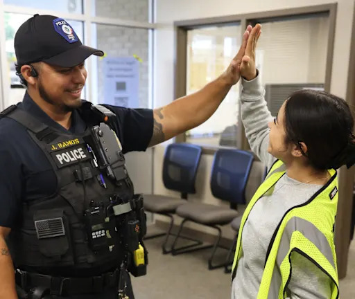 Officer Jorge Ramos giving a high five