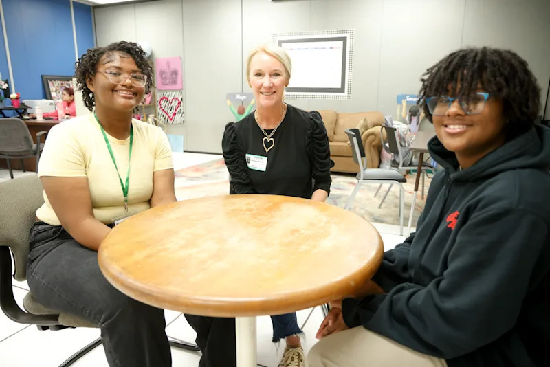 Shannon Mahan with two students