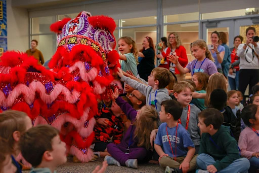 children looking at lunar new year dragon costume