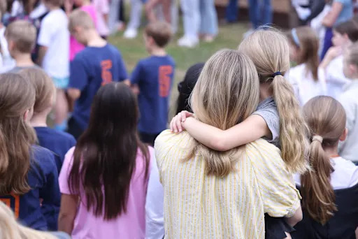 student hugging a teacher