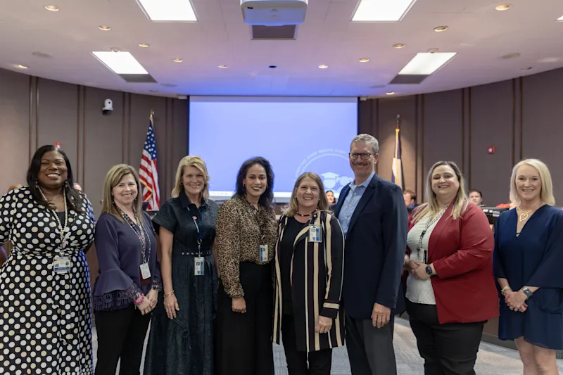 group gathered accepting recognition for excellence in financial reporting