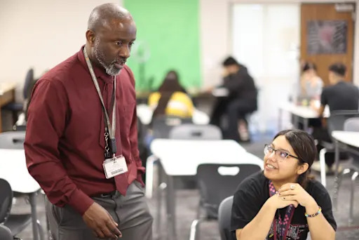 Jason Campbell speaking to a student