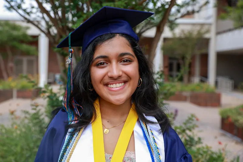 Suhani Singh smiling in graduation attire