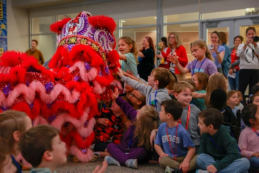 children looking at lunar new year dragon costume