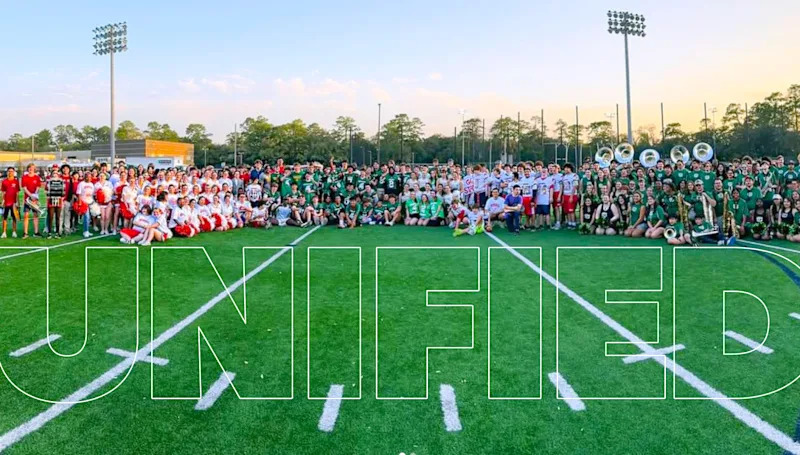 the word "Unified" over a collectoin of students sitting on a football field