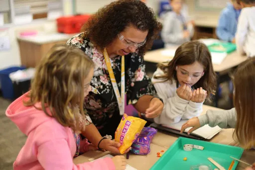 Annie Mitchell handing students candy corn