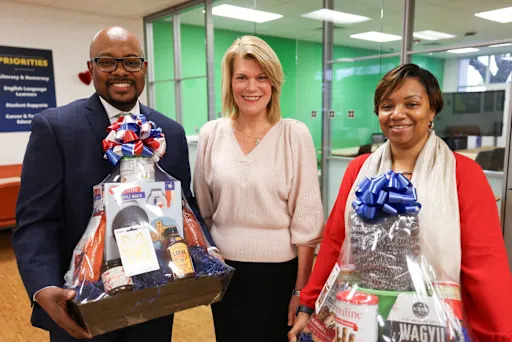 HP Hyder III and Carrmilla Young being presented with congratulatory gift baskets from Dr. Jennifer Blaine