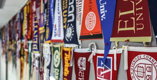 college flags pinned to the wall