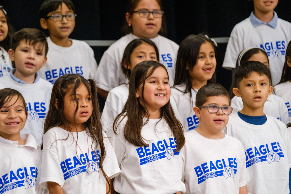 Several children in matching white shirts with the word "Beagles" printed on them.