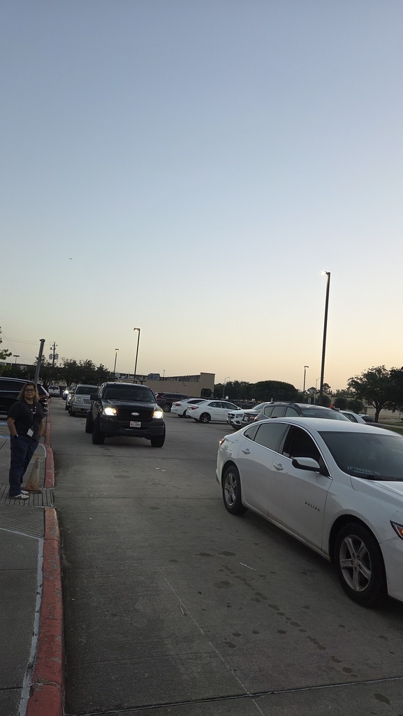 Photo of parents driving through the parent pick up line.
