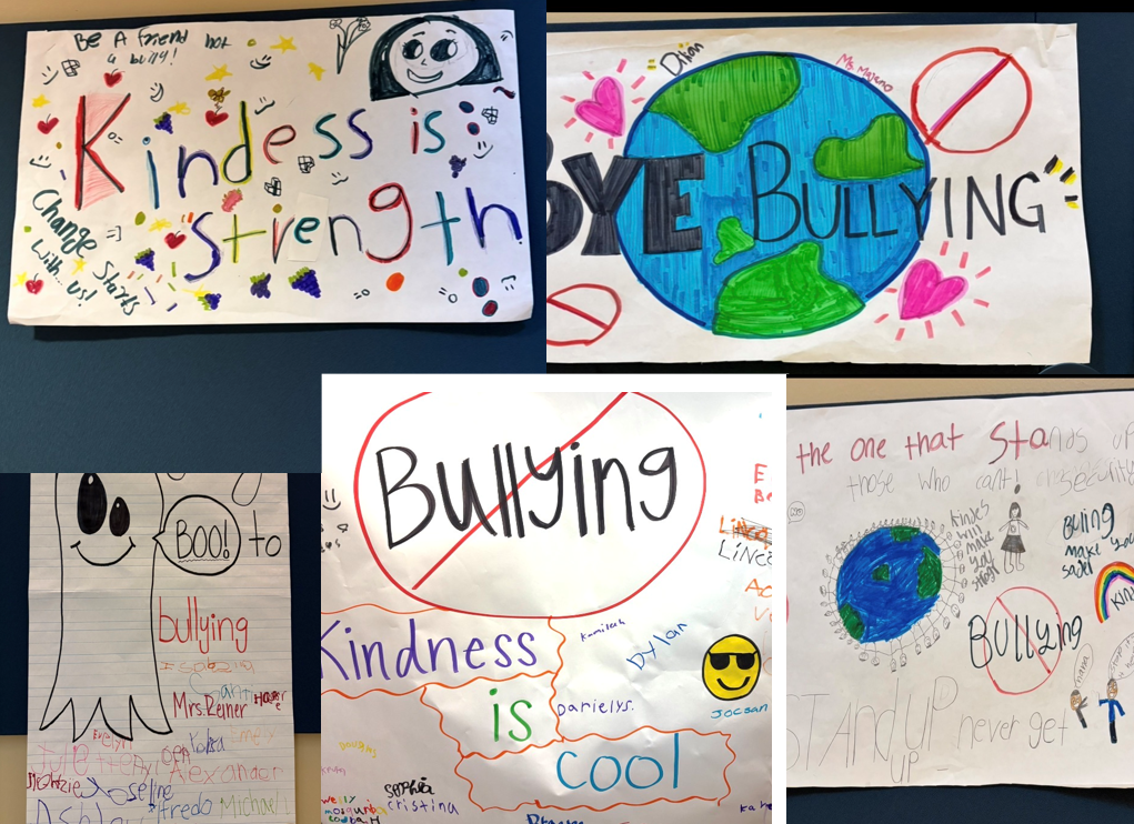 Multiple posters with drawings of Earth, hearts, smiley faces, and words like "kindness" and "bullying" on a wall.