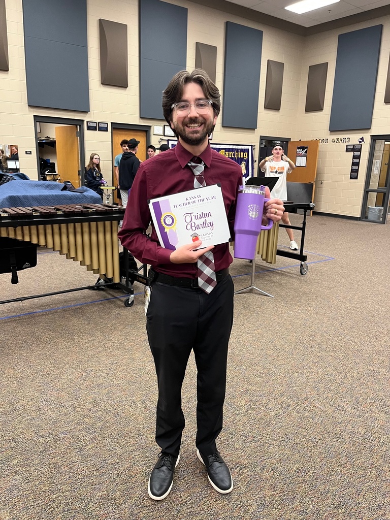Posed photo of Bartley with certificate