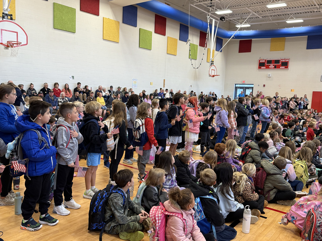 students  standing up at assembly