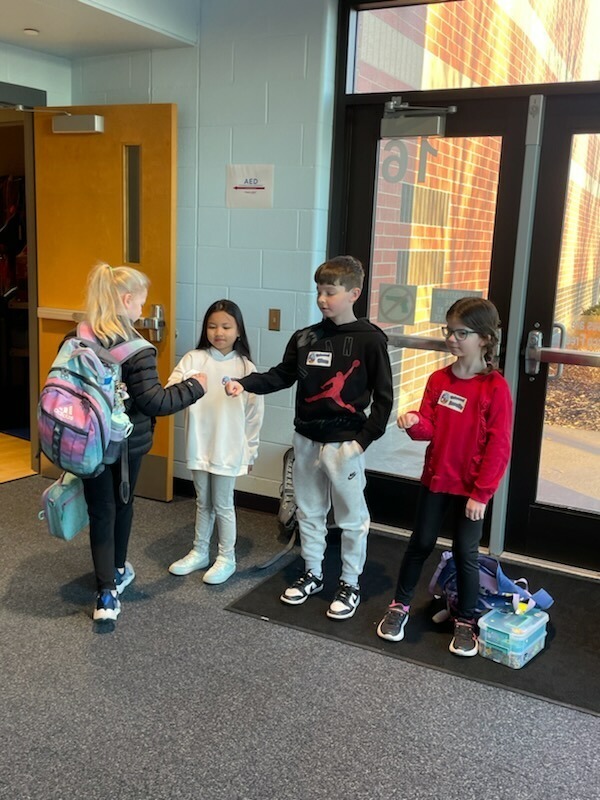 Welcome crew greeting students at morning opening