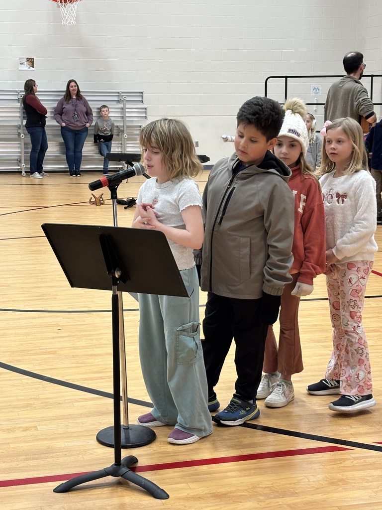 Second graders recite lines at their music program/