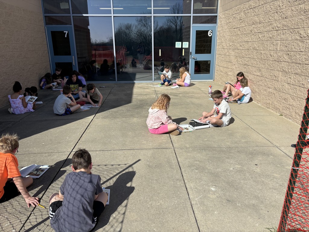3rd graders reading outside