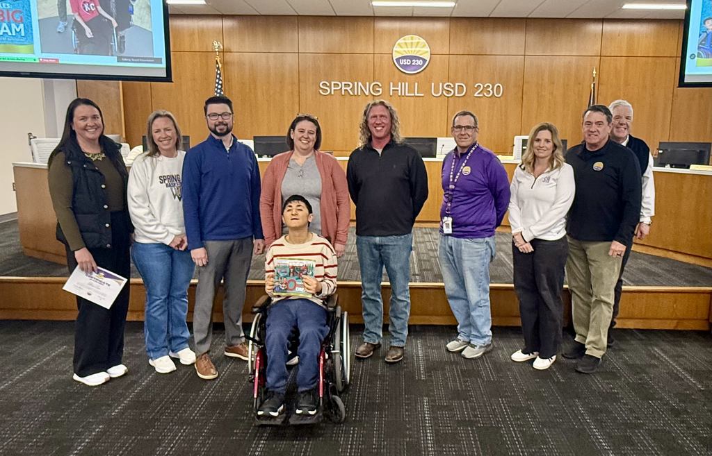 BOE Members, alongside Dr. Weber and Ms. Mary Larson, posing with Ethan Carr at BOE meeting.