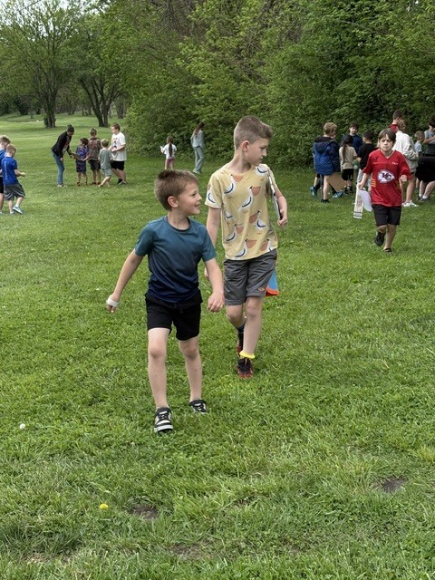Students hunting for insects outside.