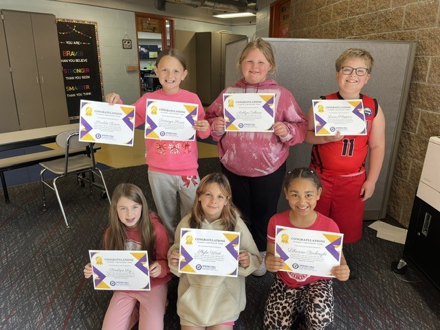 Six students standing together holding certificates.