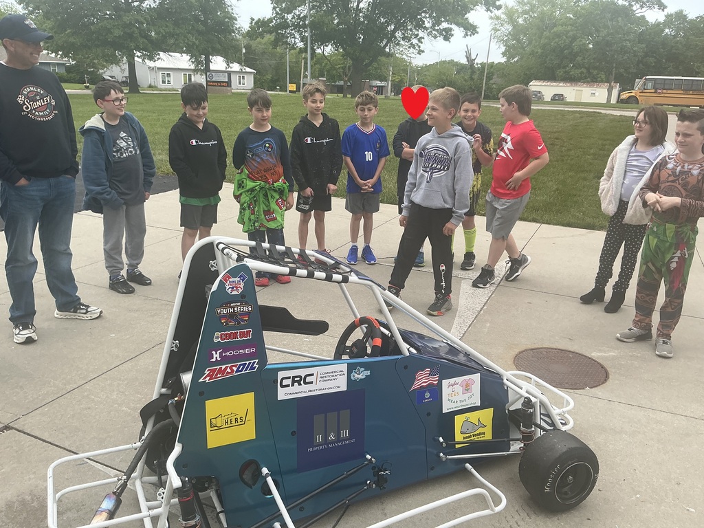 Student looking at a race car.