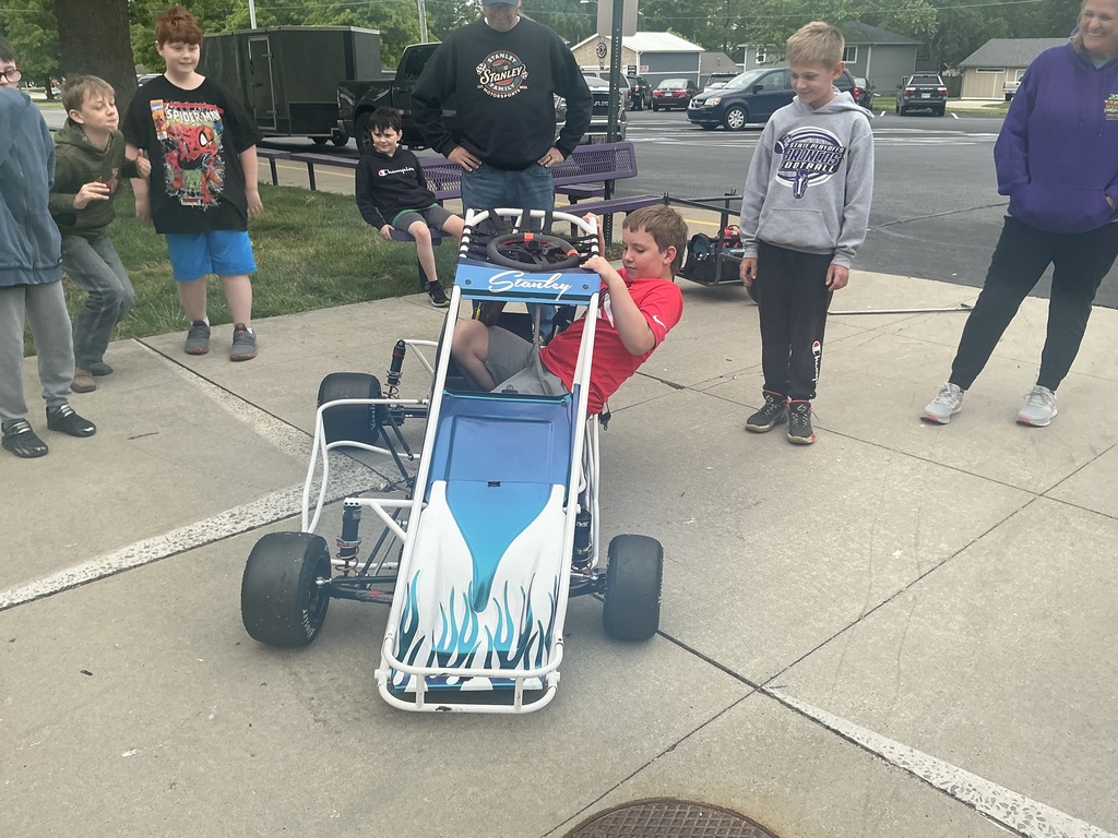 Student getting into a race car.