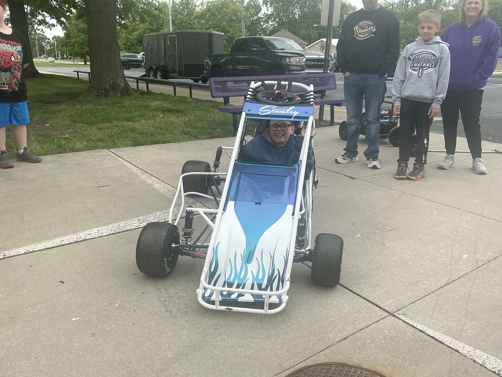 Student getting into a race car.
