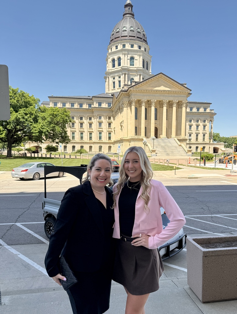 Leah Good and Ashley Anderson posing in front of the capitol building in Topeka