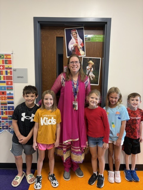 Mrs Pelkey and students pose for a picture.