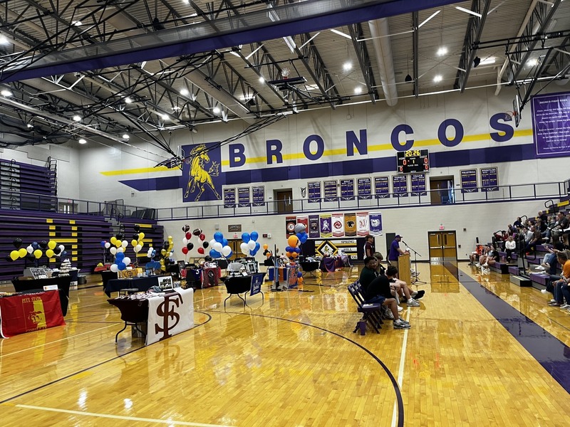 gym on signing day showing students and displays