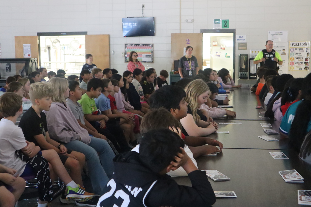 Students listening to a lesson on the American Flag