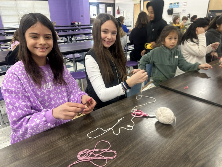 Students crafting art out of yarn