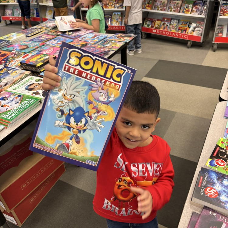 Student showing off a Sonic the Hedgehog book