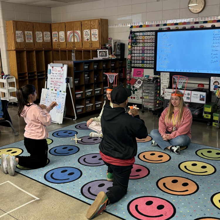 Students launching ping pong balls into a net