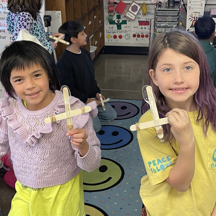Students launching ping pong balls into a net