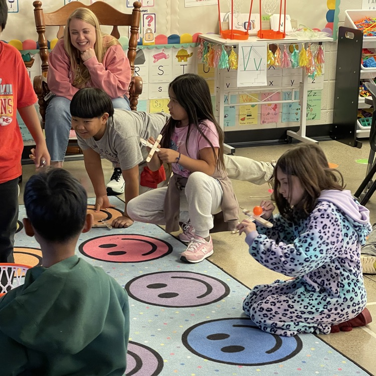 Students launching ping pong balls into a net