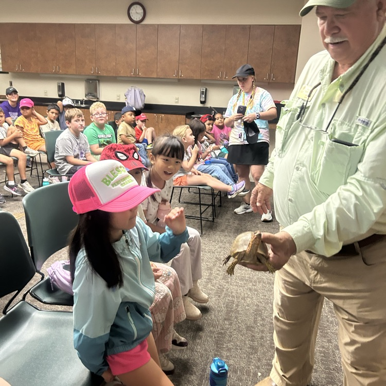 Students looking at and petting a Turtle at Hobbs State Park