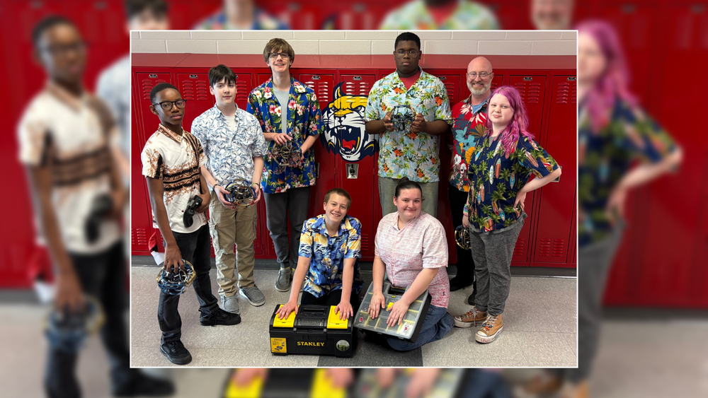 Members of the Hayward Drone Soccer Team pose for a photo in front of lockers