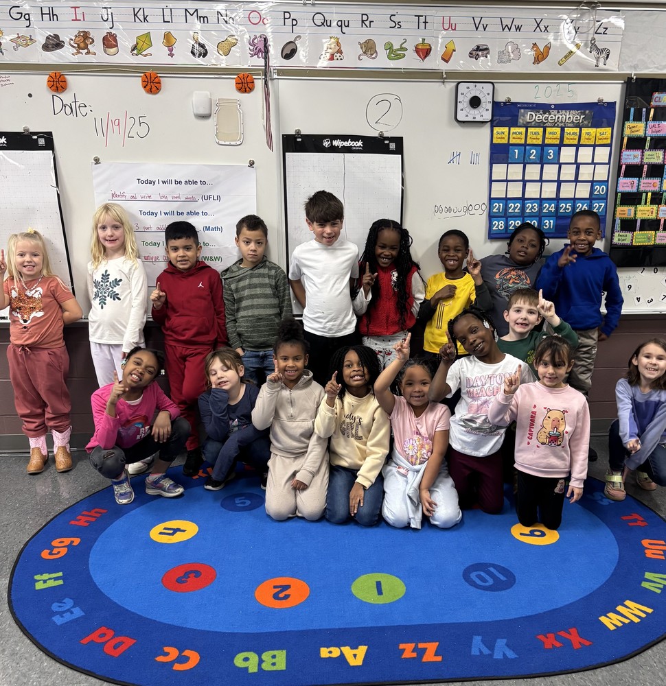 Mr. Tincher's 1st Grade Class holds up #1s