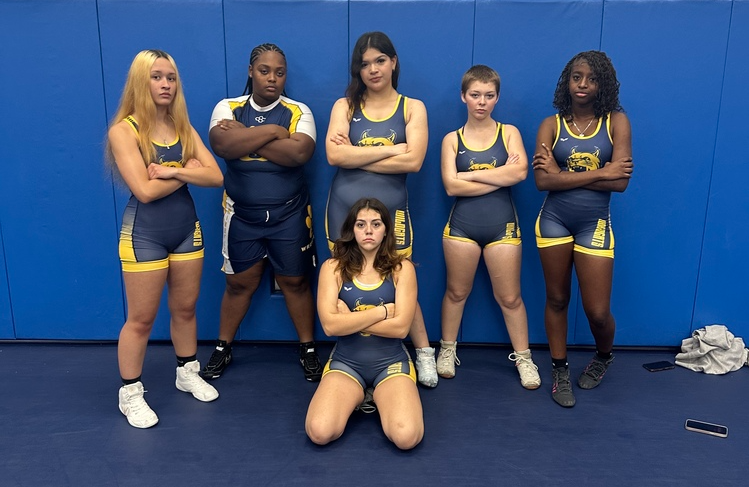 members of the shs girls wrestling team pose for a photo