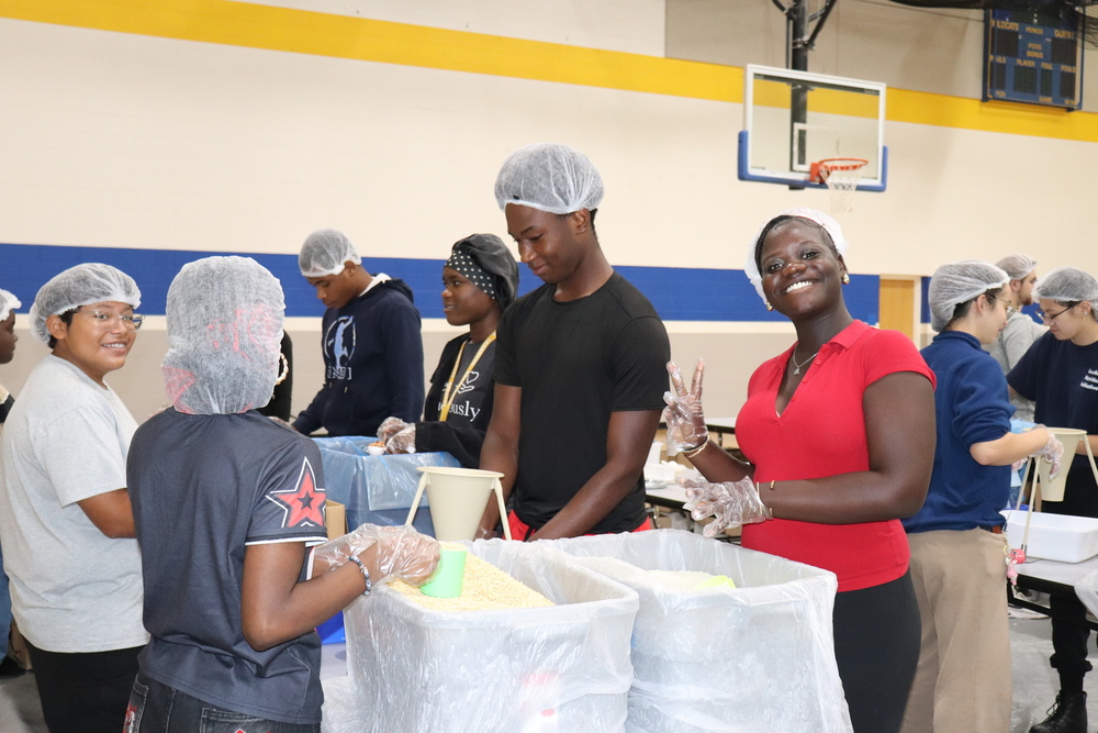 A Springfield High student packs meals in an assembly line