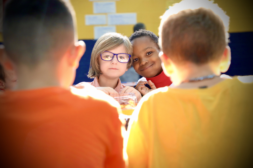 Two male students pose for a picture while sitting at Fulton's Longest Table